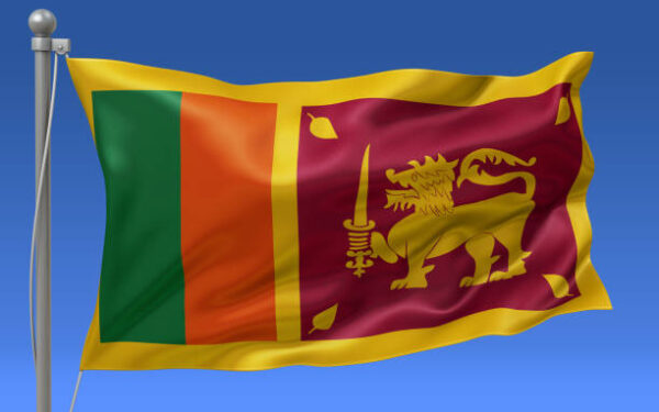 Sri Lanka flag waving on the flagpole on a sky background